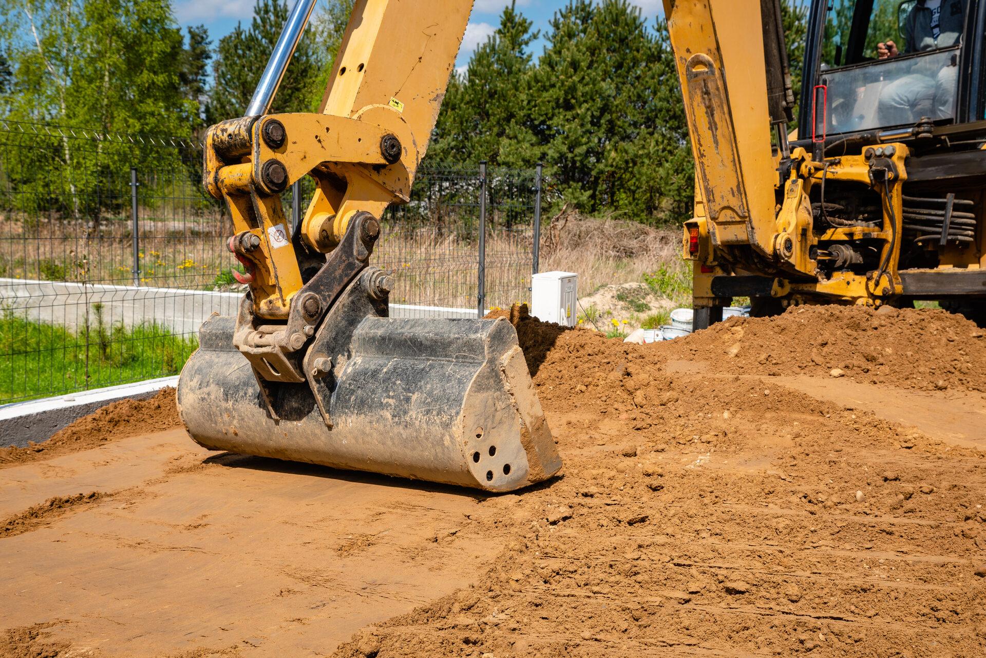 Excavator bucket digging earth