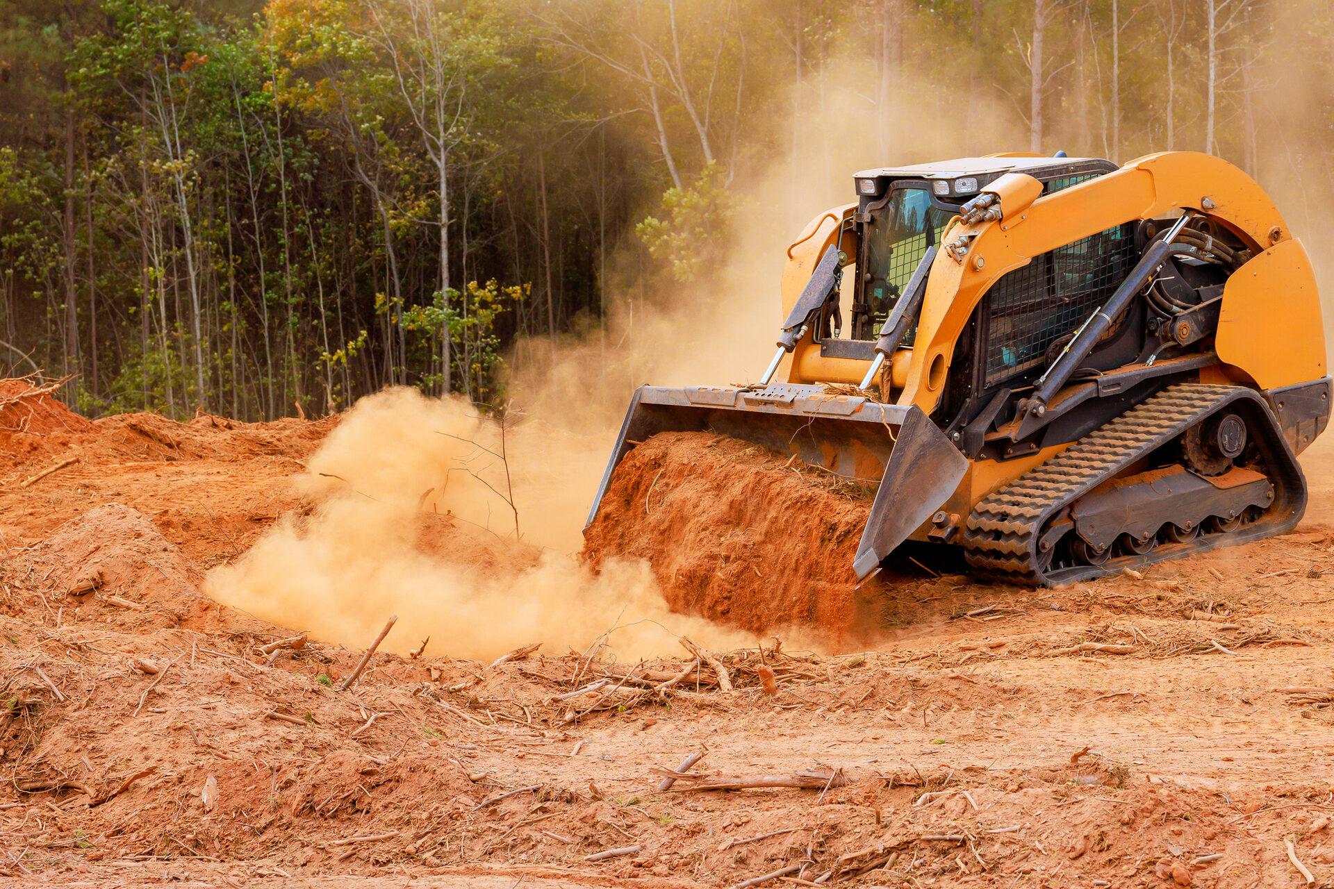Land clearing equipment moving earth